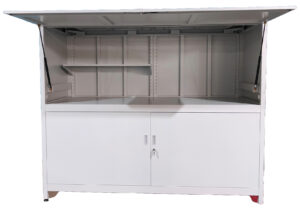 The DD-Double Decker 3 door cabinet is a white metal kiosk featuring an open top lid supported by two struts, shelves inside the upper section, and a lower storage compartment with double lockable doors.